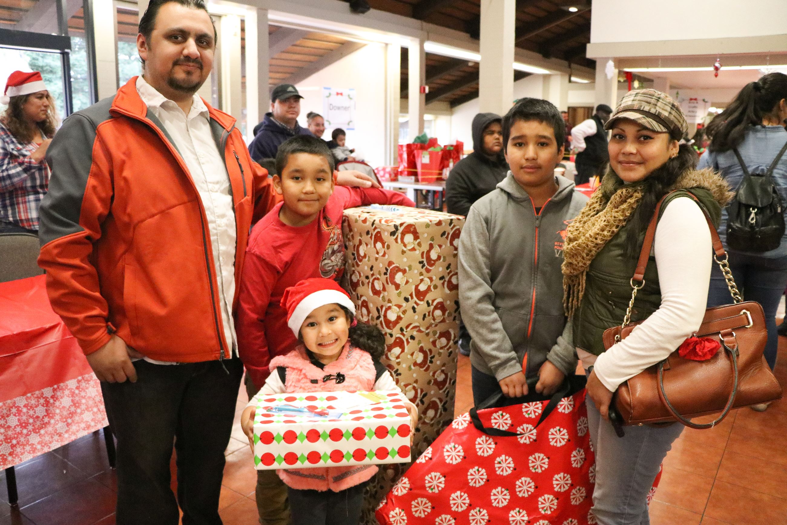 Family Receiving Gifts during Family Giving Tree Event 
